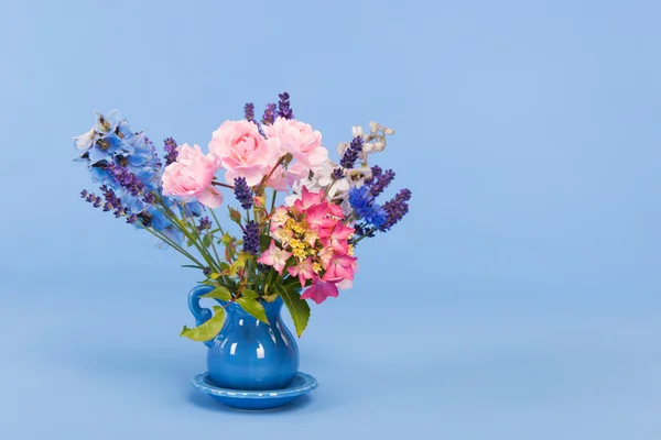 Mixed colorful bouquet on blue background — Stock Photo, Image