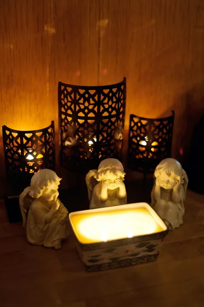 Three angels around a candle — Stock Photo, Image