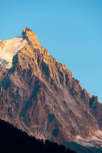 The panorama of Les Aiguilles towers in sunset light - Grands Charmoz, Aiguille du Grepon, Aiguille de Blaitiere, Aiguille du Plan and Aiguille du Midi.