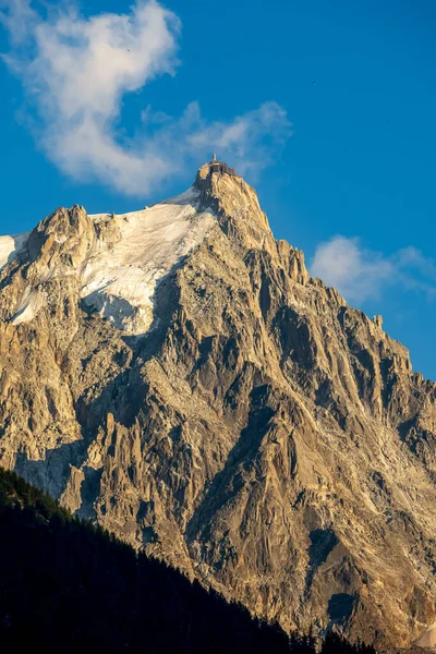 The panorama of Les Aiguilles towers in sunset light - Grands Charmoz, Aiguille du Grepon, Aiguille de Blaitiere, Aiguille du Plan and Aiguille du Midi.