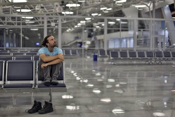 Young man waiting his flight in airport lounge — Stock Photo, Image