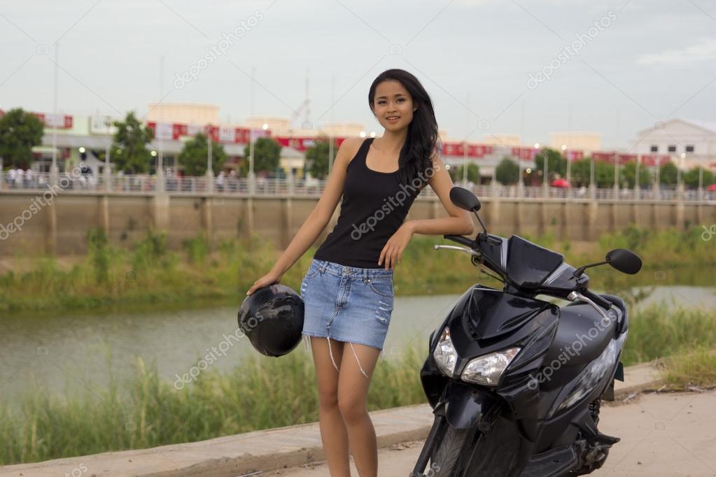 Girl in mini top skirt on motorcycle