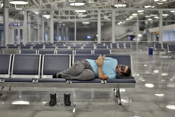 Sleeping in airport with eye cover — Stock Photo, Image