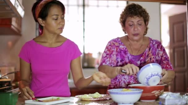 Mãe e filha preparando a refeição juntos na cozinha — Vídeo de Stock