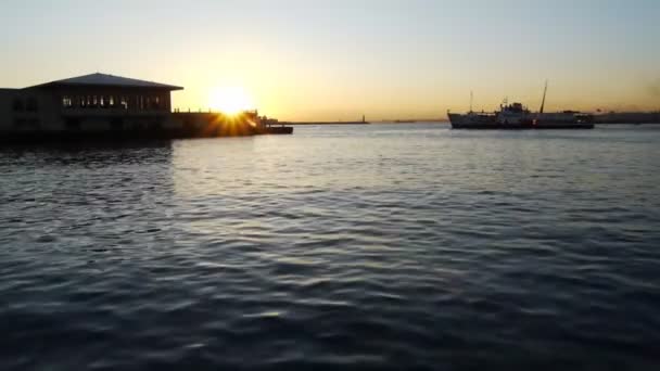 Schiff legt an einer schönen Meereslandschaft und bei Sonnenuntergang an — Stockvideo