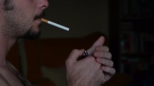 A naked young White man smoke cigarette — Stock Video