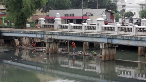 Indonesian man working in unhealthy open sewer of jakarta — Stock Video