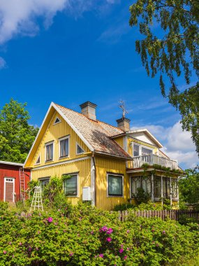 Yellow wooden cottage near Figeholm in Sweden. clipart