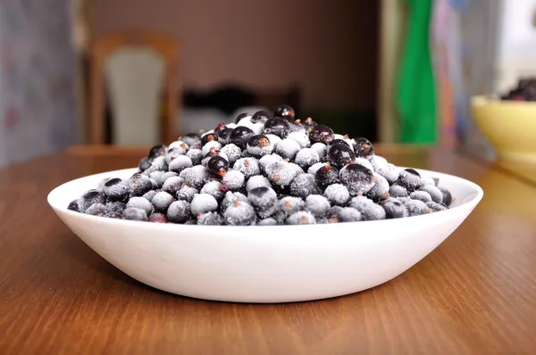 Heap of frozen black currant in the kitchen — Stock Photo, Image