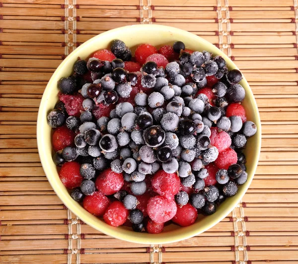 Heap of frozen black currant and cherry in a plate — Stock Photo, Image