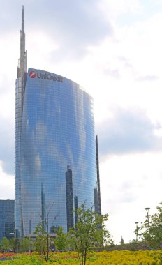 MILAN, ITALY - MAY 4, 2019: The brand new Bibliotheca degli Alberi park at Porta Nuova with the famous Unicredit building in the background, reflecting the Pirelli building and the bosco verticales