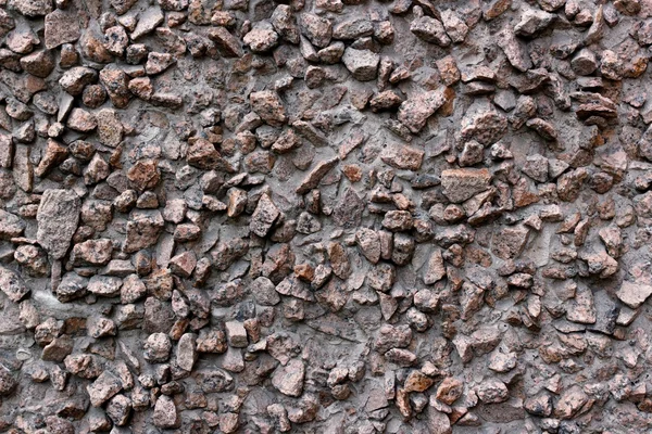 Superfície de cimento com pedras salientes — Fotografia de Stock