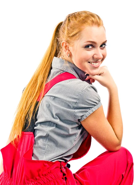 Young happy woman in red overalls — Stock Photo, Image