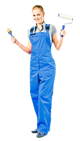 Young woman in blue overalls with painting tools — Stock Photo, Image