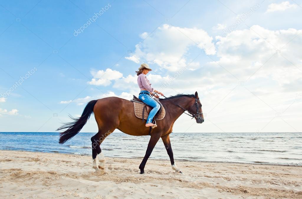 Girl with horse on seacoast