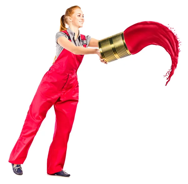 Young woman in red overalls with red paint — Stock Photo, Image