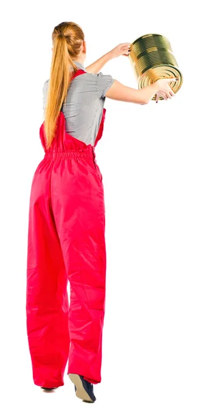 Young woman in red overalls with painting tools — Stock Photo, Image