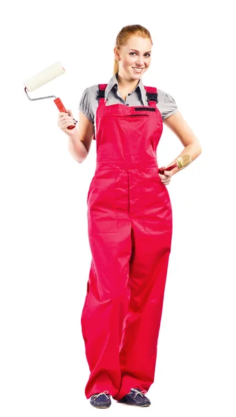 Young woman in red overalls with painting tools — Stock Photo, Image