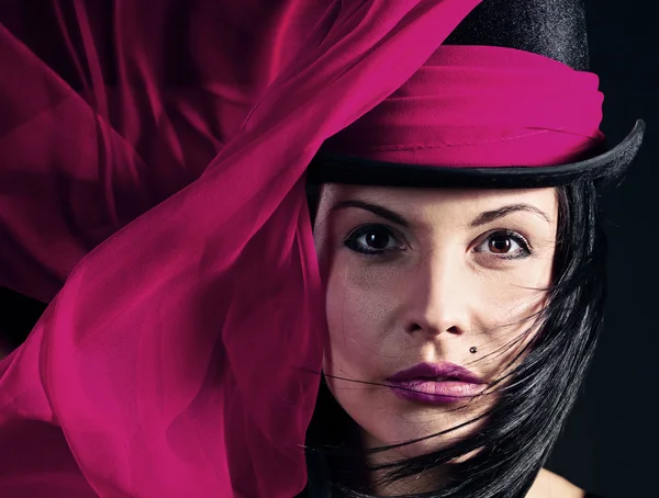 Beautiful woman in black hat with purple scarf — Stock Photo, Image