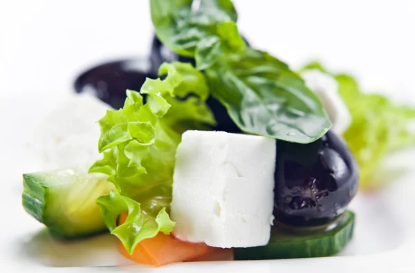 Salad with cheese and black olives — Stock Photo, Image