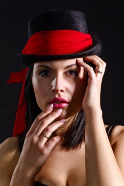woman in black hat with red scarf