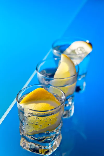 Gin with lemon on a glass table — Stock Photo, Image