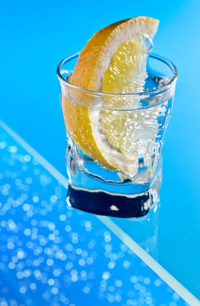 Gin with lemon on a glass table — Stock Photo, Image