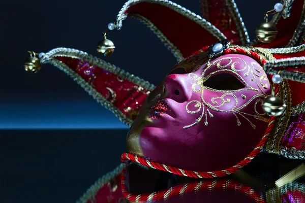 Mask with bells on a mirror table — Stock Photo, Image