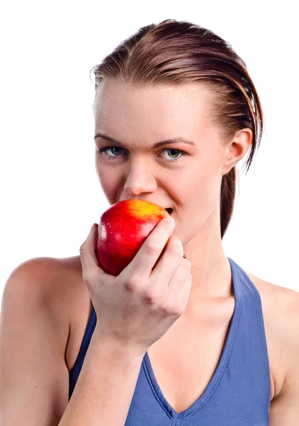 Girl in sportswear with apple — Stock Photo, Image