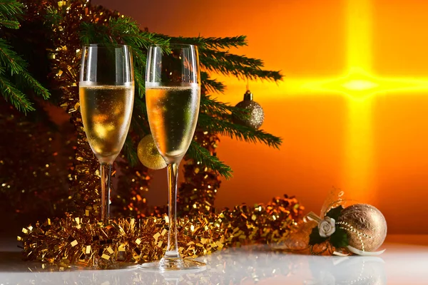 Glasses with champagne and Christmas ornaments — Stock Photo, Image