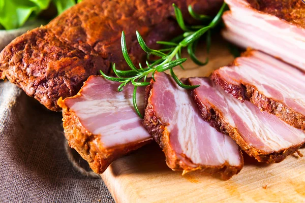 Smoked meat with rosemary — Stock Photo, Image