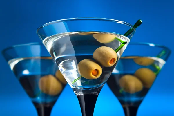 Glasses with martini and green olives — Stock Photo, Image