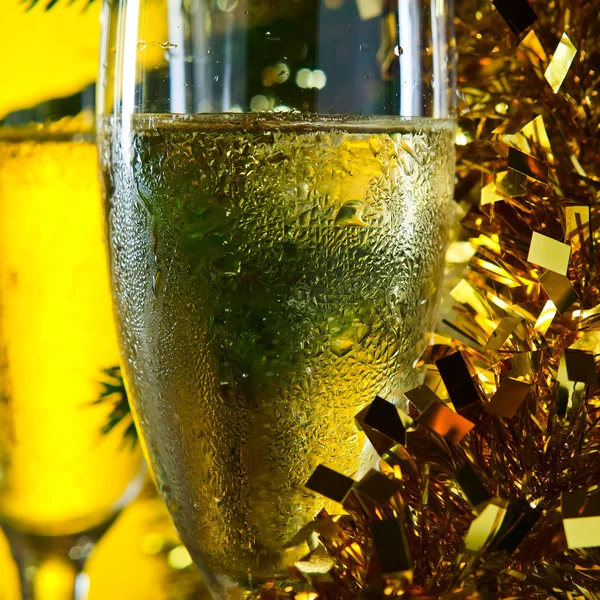 Glasses with champagne and Christmas ornaments — Stock Photo, Image