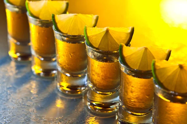 Tequila and lime on glass table — Stock Photo, Image