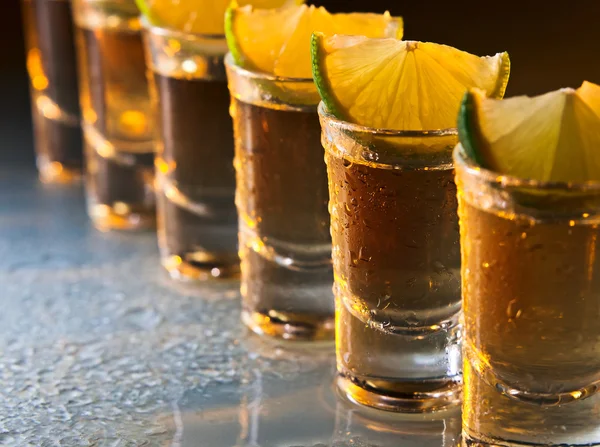 Tequila and lime on glass table — Stock Photo, Image