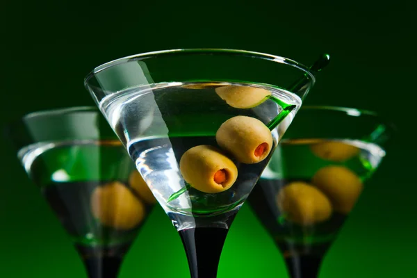 Glasses with martini and green olives — Stock Photo, Image