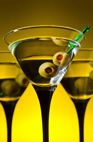 Glasses with martini and green olives — Stock Photo, Image
