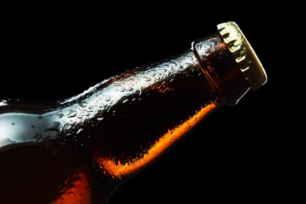 frozen beer bottle isolated on black , saved clipping path