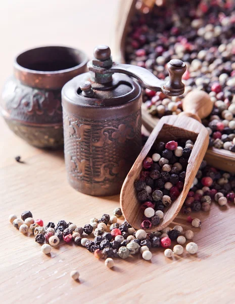 Peppercorns on wooden table — Stock Photo, Image