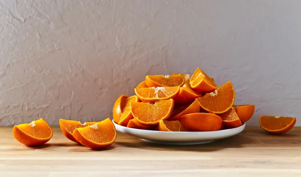Cut tangerines on wooden table — Stock Photo, Image