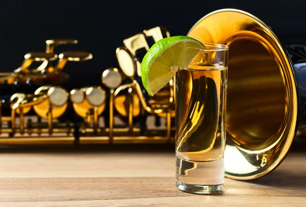 Saxophone and tequila with lime — Stock Photo, Image