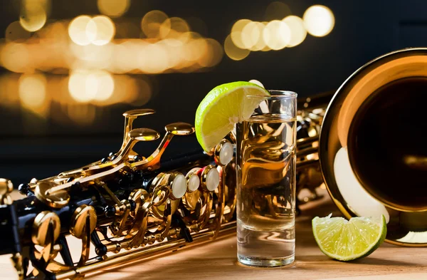 Saxophone and tequila with lime — Stock Photo, Image