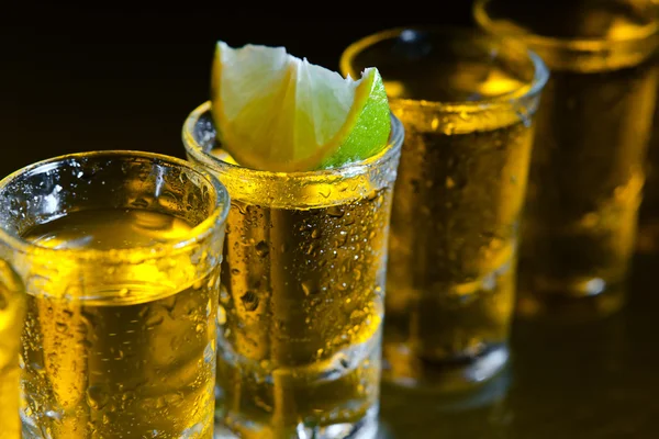 Tequila and lime on glass table — Stock Photo, Image