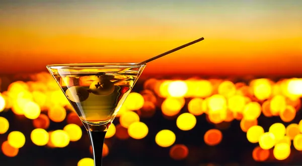 Glass with martini and green olives — Stock Photo, Image