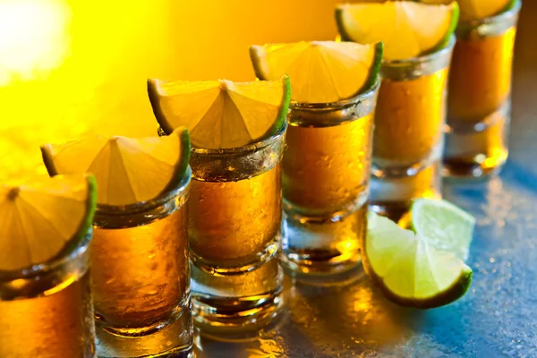 Tequila and lime on glass table — Stock Photo, Image