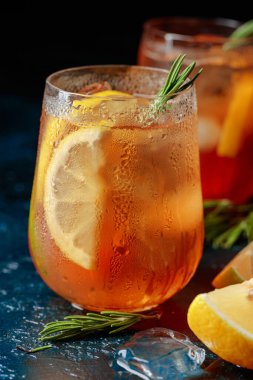 Geleneksel limonlu buzlu çay, biberiye ve koyu mavi bir masada buz..