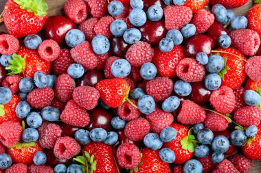 Berries close-up colorful assorted mix of strawberry, blueberry, raspberry and sweet cherry. Top view.