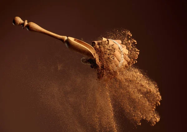 Tarçın Tozu Ahşap Kaşıktan Dökülüyor Zemin Tarçın Tarçın Çubukları Kahverengi — Stok fotoğraf