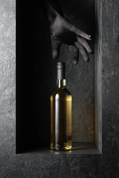 Woman Hand Black Glove Reaches Bottle White Wine Concept Image — стоковое фото