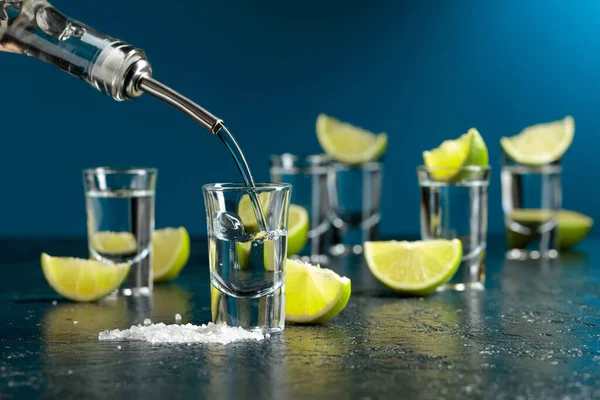 Tequila Poured Glass Tequila Shots Lime Slices Sea Salt — Foto Stock